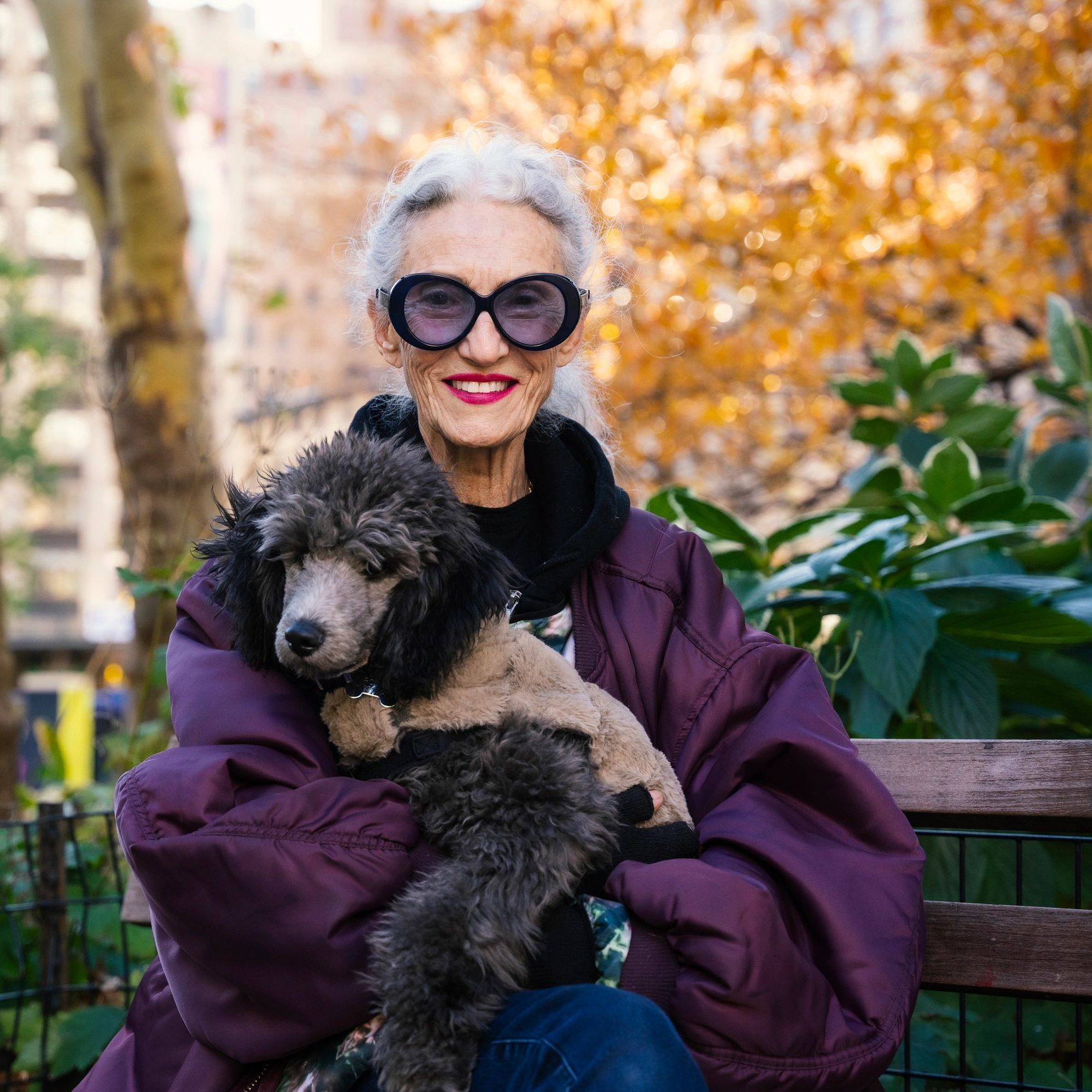 Portrait of a senior woman outdoors with her dog