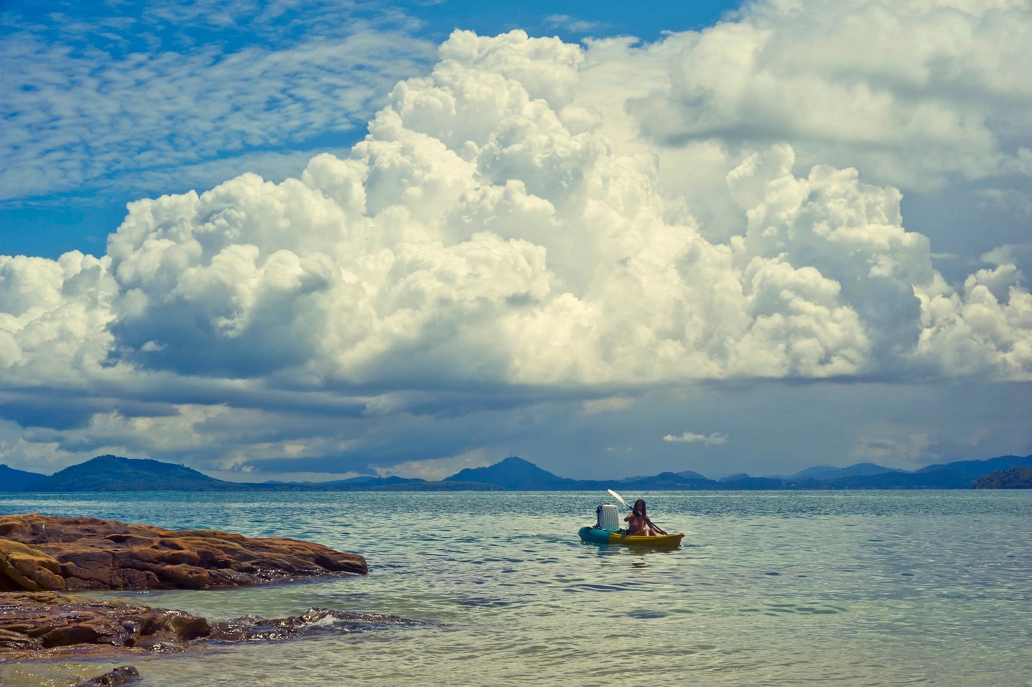Woman on a kayak adventure exploring tropical islands